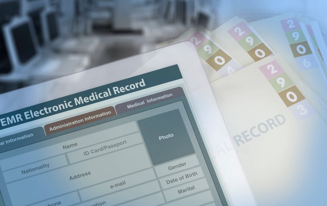 Table screen displaying EMR Electronic Medical Record across the top as it sits on medical files.